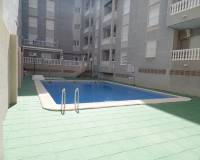 a sun terrace around the communal pool included in this apartment for sale with zebra homes real estate guardamar