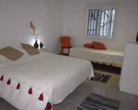 large white bed in bedroom of villa for sale crevillente