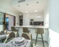 breakfast bar and stool in open plan kitchen in new luxury golf villa for sale