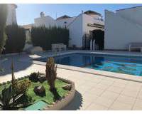 sun terrace surrounds communal pool used by owners of these villas for sale el raso