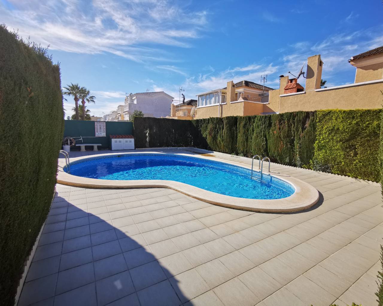sun terrace around community swimming pool enjoyed with property for sale